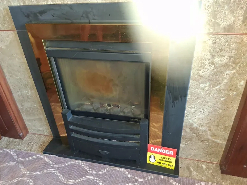 Gas fire tagged with a Danger - Do Not Use safety warning